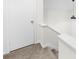 Carpeted stairwell featuring a door and neutral paint at 2693 Greentree Se Dr, Marietta, GA 30067