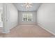 Carpeted bedroom featuring a ceiling fan and a window providing natural light at 2732 Pierce Brennen Ct, Lawrenceville, GA 30043