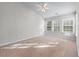 Spacious bedroom with three windows providing natural light, and neutral carpet enhancing comfort and style at 2732 Pierce Brennen Ct, Lawrenceville, GA 30043