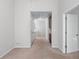 Hallway with neutral carpet providing access to various rooms, showcasing the home's layout and flow at 2732 Pierce Brennen Ct, Lawrenceville, GA 30043