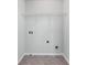 Unfinished laundry room offering essential connections for washer and dryer, and a wire shelf for storing supplies at 2732 Pierce Brennen Ct, Lawrenceville, GA 30043