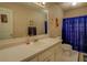 Standard bathroom with wallpaper, vanity, mirror, toilet, and blue shower curtain at 293 Country Lake Dr, Mcdonough, GA 30252