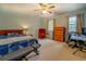 Bedroom with neutral carpet, ceiling fan and computer setup at 293 Country Lake Dr, Mcdonough, GA 30252