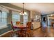 Dining room with hardwood floors, large windows, chandelier, and views of the kitchen at 293 Country Lake Dr, Mcdonough, GA 30252