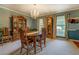 Traditional dining room with a large wooden table, chandelier, and ample natural light at 293 Country Lake Dr, Mcdonough, GA 30252