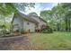 View of the home's side exterior with a garage, back porch and well-maintained yard at 293 Country Lake Dr, Mcdonough, GA 30252