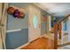 Inviting foyer featuring a decorative front door, wood floors, and staircase at 293 Country Lake Dr, Mcdonough, GA 30252
