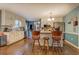 Bright eat-in kitchen with breakfast bar, white cabinets, stainless steel appliances, and hardwood flooring at 293 Country Lake Dr, Mcdonough, GA 30252