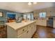Spacious kitchen with large island, stainless appliances, and hardwood floors that open to other rooms at 293 Country Lake Dr, Mcdonough, GA 30252