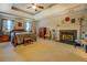 Spacious bedroom with a fireplace and decorative tray ceiling at 293 Country Lake Dr, Mcdonough, GA 30252