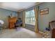 Cozy home office with a vintage roll-top desk, chair, and ample natural light at 293 Country Lake Dr, Mcdonough, GA 30252