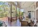 Spacious back porch with outdoor seating, string lights, and wooded views at 3137 Perimeter Cir, Buford, GA 30519