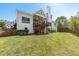 Expansive backyard with lush lawn, mature trees, and a multi-tiered deck and stairs at 3137 Perimeter Cir, Buford, GA 30519