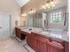 Bright bathroom with double sinks, granite countertops, and ample cabinet storage at 3137 Perimeter Cir, Buford, GA 30519