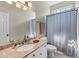 Well-lit bathroom with granite countertop, vanity, mirror and a shower with curtain at 3137 Perimeter Cir, Buford, GA 30519