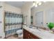 Standard bathroom featuring dark cabinets, a granite countertop, and a patterned shower curtain at 3137 Perimeter Cir, Buford, GA 30519