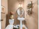 Elegant powder room features pedestal sink, stylish decor, and warm neutral tones at 3137 Perimeter Cir, Buford, GA 30519