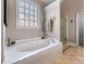 Elegant bathroom features a large soaking tub and separate glass-enclosed shower at 3137 Perimeter Cir, Buford, GA 30519
