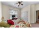Cozy bedroom features plush carpet, ceiling fan, large closet, and natural light from the window at 3137 Perimeter Cir, Buford, GA 30519