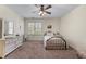 Bedroom with carpeted floors, ceiling fan, and a window that provides natural light at 3137 Perimeter Cir, Buford, GA 30519