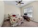 Comfortable bedroom with a floral-patterned bedspread, ceiling fan and a window with natural light at 3137 Perimeter Cir, Buford, GA 30519