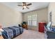Comfortable bedroom with plush carpet, a ceiling fan, window with natural light, and wooden furniture at 3137 Perimeter Cir, Buford, GA 30519