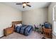 Standard bedroom with plush carpet, a ceiling fan, window with natural light, and wooden furniture at 3137 Perimeter Cir, Buford, GA 30519