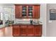 Butler pantry featuring granite countertops and glass front cabinets at 3137 Perimeter Cir, Buford, GA 30519