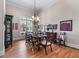 Elegant dining room with hardwood floors, a large window, and a stylish chandelier at 3137 Perimeter Cir, Buford, GA 30519