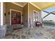 Charming front porch with stone flooring, double doors, and a welcoming bench area at 3137 Perimeter Cir, Buford, GA 30519