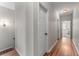 Bright hallway with hardwood floors and doors leading to various rooms at 3137 Perimeter Cir, Buford, GA 30519