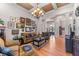 Bright living room with hardwood floors, coffered ceiling, and an array of art pieces at 3137 Perimeter Cir, Buford, GA 30519