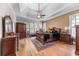 Spacious main bedroom features tray ceiling, hardwood floors, and elegant wood furniture at 3137 Perimeter Cir, Buford, GA 30519