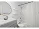 Bathroom with tile surround shower, floating shelves, and grey vanity at 6940 Roswell Rd # 24E, Sandy Springs, GA 30328