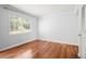 Bright bedroom featuring hardwood floors, a window, neutral walls, and a closet at 6940 Roswell Rd # 24E, Sandy Springs, GA 30328