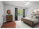 Bright staged bedroom featuring hardwood floors, and a bed with stylish decor at 6940 Roswell Rd # 24E, Sandy Springs, GA 30328