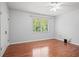 Comfortable bedroom with hardwood floors, ample natural light, and neutral tones at 6940 Roswell Rd # 24E, Sandy Springs, GA 30328