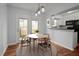 Cozy dining area with hardwood floors, leading to a kitchen and exterior patio at 6940 Roswell Rd # 24E, Sandy Springs, GA 30328