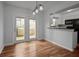 Bright dining area with hardwood floors, connected to the kitchen and patio at 6940 Roswell Rd # 24E, Sandy Springs, GA 30328