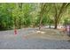 Community dog park featuring a fenced area with gravel, fire hydrant, and seating at 6940 Roswell Rd # 24E, Sandy Springs, GA 30328