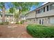 Exterior shot of multi-Gathering home featuring well-maintained landscaping and large trees at 6940 Roswell Rd # 24E, Sandy Springs, GA 30328