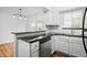 Bright kitchen with stainless steel dishwasher, white cabinets, and a breakfast bar at 6940 Roswell Rd # 24E, Sandy Springs, GA 30328