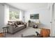 Bright living room featuring hardwood floors, neutral walls, and ample natural light from a large window at 6940 Roswell Rd # 24E, Sandy Springs, GA 30328