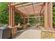 Community pergola with stone columns providing a shaded seating area at 6940 Roswell Rd # 24E, Sandy Springs, GA 30328