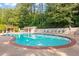 Community pool area with lounge chairs and well-maintained landscaping at 6940 Roswell Rd # 24E, Sandy Springs, GA 30328
