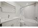 Modern bathroom featuring a vanity, mirror, and tub with white and gray patterned shower curtain at 2433 Helmsdale Ne Dr, Atlanta, GA 30345
