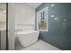 Modern bathroom featuring a standalone tub, sleek tiling, and a view of the outdoors at 2433 Helmsdale Ne Dr, Atlanta, GA 30345