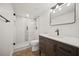 Modern bathroom featuring a glass shower, black hardware and a dark wood vanity at 2433 Helmsdale Ne Dr, Atlanta, GA 30345
