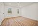 Sun-filled bedroom boasts beautiful hardwood floors and large windows offering exterior views at 2433 Helmsdale Ne Dr, Atlanta, GA 30345