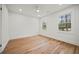 Bright bedroom featuring hardwood floors, a ceiling fan and two large windows at 2433 Helmsdale Ne Dr, Atlanta, GA 30345